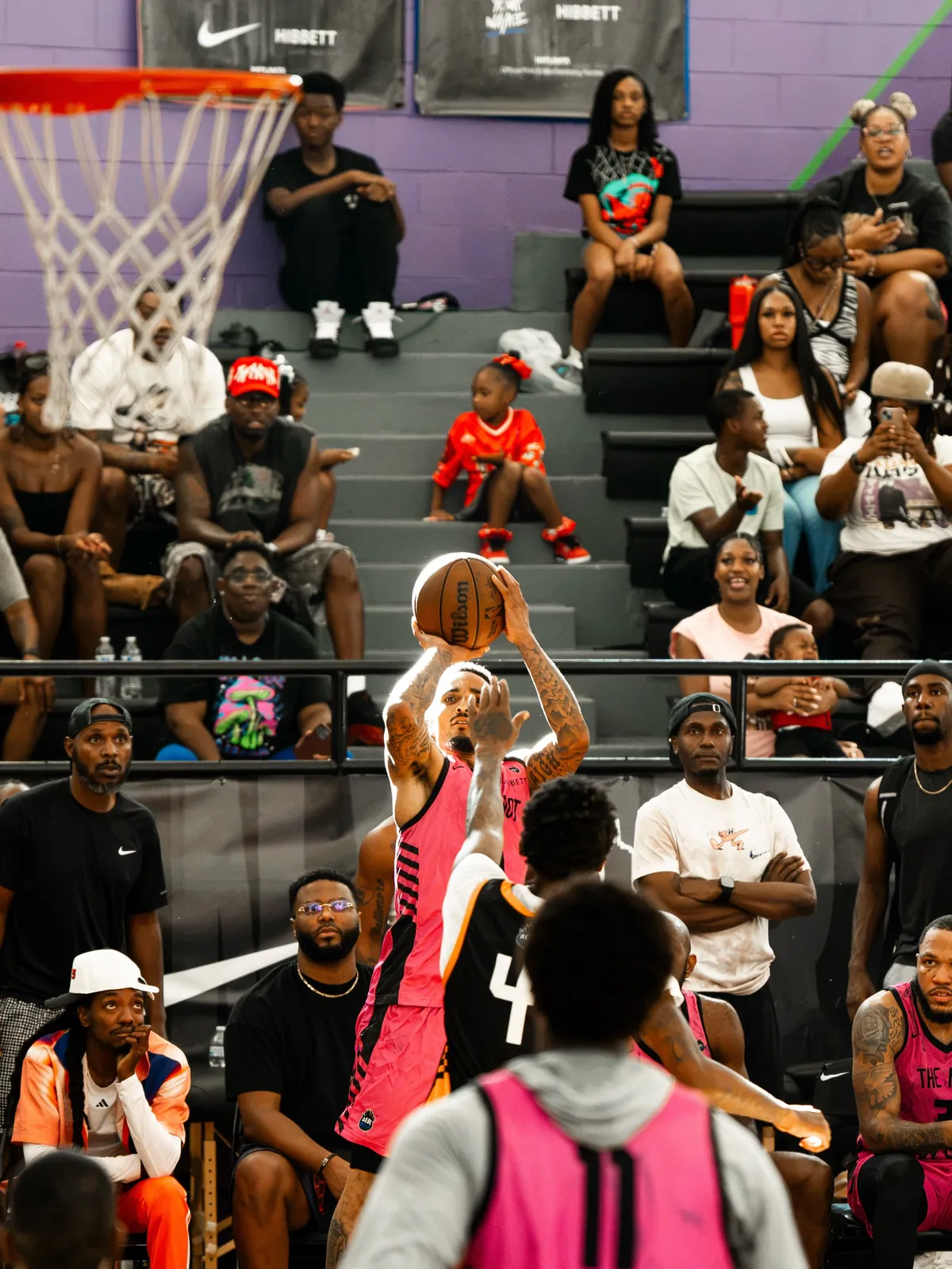 A player shooting a jump shot in front of packed stands at an AEBL game