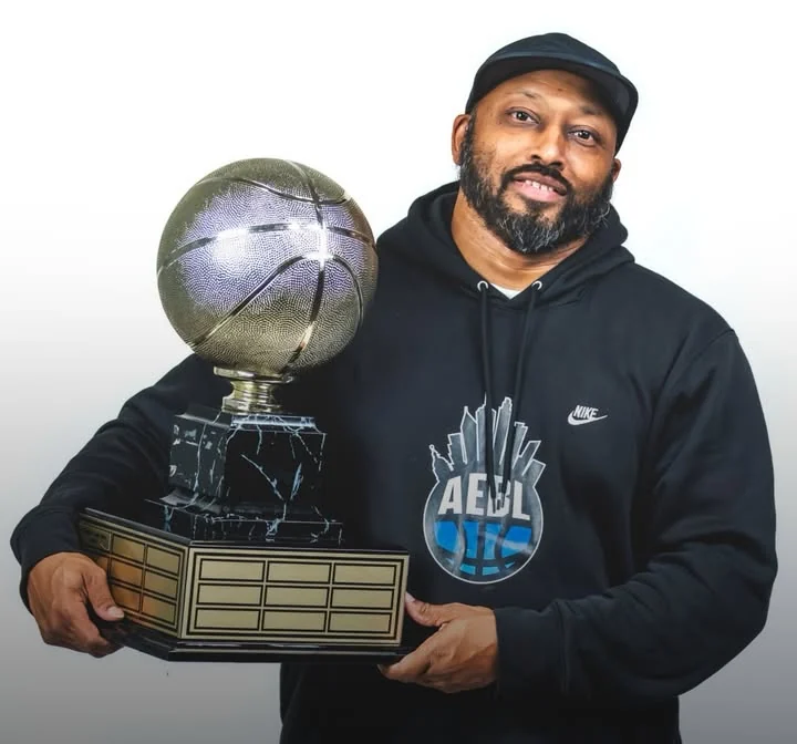 Jahi Rawlings, founder and commissioner of the AEBL, holding a league trophy